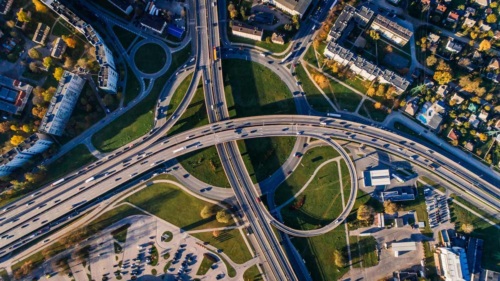 Aerial view of a busy highway surrounded by homes and apartment buildings.